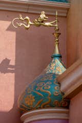 An Arabic fabric pattern embellishes the fuchsia walls of Jasmine’s tower, which features a turquoise dome with Abu as the golden finial. 

Photo: ©Disney