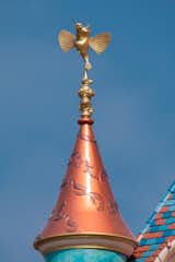 Pocahontas’ story is depicted through a bas relief of flowing leaf patterns on the turret with a turquoise band representative of her iconic necklace. Her hummingbird companion serves as the golden finial on top.

Photo: ©Disney