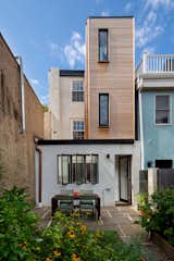 Clear cedar clads a contemporary light filled addition that opens the house to the rear garden and outdoor living spaces.