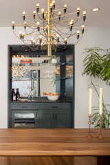 Dining Room, Table, Light Hardwood Floor, Bar, and Pendant Lighting The "alcove bar" in the dining room, in Amazon Green by Benjamin Moore.  Photo 8 of 15 in Fitler Square Double Wide Rowhouse by Lauren Thomsen Design