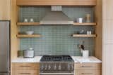Heath tile backsplash gives a subtle pop of color to the kitchen.