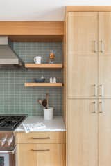 Floating shelves adjacent to full height storage.