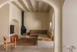 The living room became compact and cozy with Migual Mila's Cerandya fireplace from DAE, a bespoke sofa set-up and TV screen tucked into an original arch.
