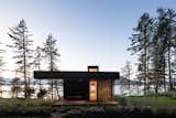 Exterior, Flat RoofLine, and Cabin Building Type Illuminated roof lanterns beckon to visitors, who must descend a forested roadway to approach Bowen Island House.  Photo 4 of 11 in A Glass and Cedar Cabin Looks Out Over One of British Columbia’s Best Views