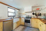 Renovated existing kitchen with new elongated subway tiles, new wood countertop and repainted cabinets.
