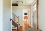 Exposed wooden beams from the original structure and wood ceiling.