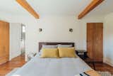 Guest queen bedroom with original wood door.