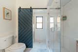 Guest bathroom on the 1st floor with new custom wood sliding door.