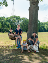 Homeowners Wim and Muriel pose in the backyard with their sons, Rio and Yenno, and their pup, Lola.  Photo 2 of 11 in A Belgian Photographer’s Country Home Is a Playground for Kids and Adults Alike