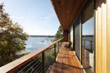 An expansive deck stretches a total of 638 sqf around the side of the home, offering immediate proximity to the river's natural rhythms.  Photo 4 of 17 in Budget Breakdown: This $851K Riverside Home Is a Case Study in Smart, Sustainable Living