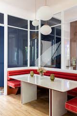 Previously a disused vestibule, now the heart of the home: the refreshed dining booth now serves as the "visual crossroads  Photo 8 of 17 in Budget Breakdown: A Diner-Style Booth Is the Beating Heart of This Refreshed Family Home in France