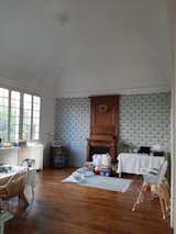 Before: With its vaulted ceiling, central fireplace and French windows (known as "portes-fenêtres