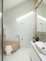 Like the kitchen benchtops, the vanity in the primary bathroom is made of quartize with veins that Litera likens to a "spider's web".