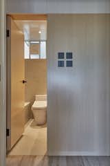 After: Consistency of tones keeps the water closet looking chic.  Photo 18 of 23 in Before & After: Built-In Storage Unlocks the Potential of a Family’s Small Hong Kong Flat