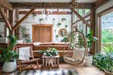The Hunter Barnhouse by Danielle and Ely Franko living room with hanging chair and plant wall