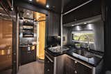 In the compact kitchenette at the rear of the Atlas, you can muster up meals beyond the road trip standards of hot dogs and s'mores. A Kohler faucet, deep sink, two gas burners, and a convection microwave oven help expand your menu options, in addition to an impressive amount of storage.  