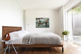Bedroom, Bed, Ceiling, Medium Hardwood, Night Stands, and Lamps Master bedroom, Maison JJ Joubert  Bedroom Ceiling Medium Hardwood Bed Photos from An Optometrist’s Midcentury Ranch House in Montreal Gets a Clear-Sighted Renovation