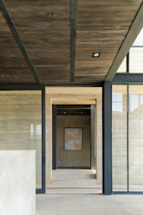 The materials create an ordered and constant geometry as the corridor moves from inside to out and back again.