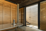 Above the dining room and kitchen, the office provides a visually simple space for the architects to work. 