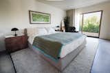 Master bedroom 1 with blackout and sheer curtains, large closet, private patio, and en suite bathroom. 