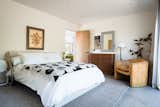 Bedroom 4 with blackout and sheer curtains, closet with luggage rack, private patio, and access to Jack and Jill shared bathroom. 