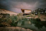 The Periphery's cantilevered deck extends into the desert, hovering lightly above slickrock and wetlands.

