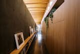 The circulation corridor hides deep storage behind custom millwork that acts as a canvas for changing light and shadow plays throughout the day.

