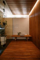 An African mahogany steam shower in the primary bedroom suite is crowned with clerestories to bring in natural light. 

