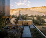 A private courtyard creates shelter from wind and sun, centered around a wood-fired hot tub from Goodland.

