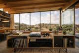 A moment of intimacy — record collection and personal objects integrated into the living space. Custom media console by Locus Studio.

