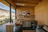 The work studio with built-in desk and storage also houses a fold-out sofa to accommodate extra guests. 

