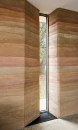 Jobe Corral Architects River Ranch house with slot window built into rammed-earth wall.