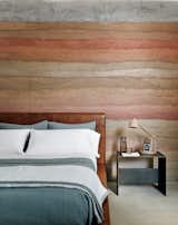 Jobe Corral Architects River Ranch house bedroom with rammed-earth wall.