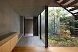 "We wanted to connect their lifestyle to the design and the materials," says Ashizawa. The Nanaminoki tree and other plantings outside the wide windows bring a green into an otherwise minimalist palette. 