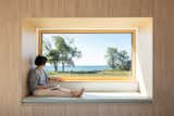 The parents’ bedroom is intentionally small, with a custom storage unit framing a giant window. “It makes the views feel that much bigger,” says Handa.
