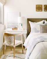 In a pinch, a desk can replace a bedside table, as demonstrated in this bedroom by designer Kate Lester. 