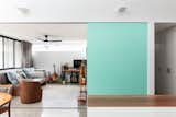 The sliding door between the kitchen and living room is painted a shade of sky blue that matches a hue favored by Italian bike brand Bianchi—a nod to Ben’s previous passion for cycling. Chiseling the track into the concrete floor was no easy task, but builder Miso Building made it happen. 