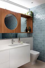 The newer downstairs bathroom features textured sky-blue tiles that nod to the natural ceramics Rose loves.