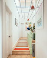 The banister was stripped back and painted in mint, and Mat took out the ceiling to reveal the existing roof structure. The new skylight above allows daylight into the previously cave-like hallway.