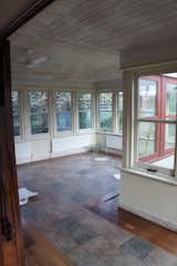 Before: The original kitchen featured a mix of tile and plank flooring, and a wood-paneled ceiling.  Photo 6 of 12 in Before & After: A Rower Couple’s London Residence Amplifies Light and Space