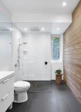 
The bathroom floor is grey porcelain, equipped with radiant heating. A cedar wall adds a different kind of warmth to the space. 
