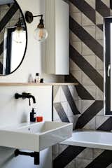 Black-and-white tiles infuse an otherwise minimalist bathroom with style.