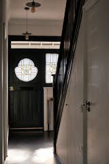 The front door and staircase were painted black to match the Victorian’s steel elements without significantly increasing the renovation costs.