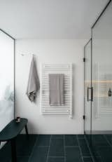 The original ensuite featured an awkward triangular shower, and was, as Daniel recalls, “the size of a closet. It looked like a powder room.” Clever use of millwork redirected the light from the skylight away from the bedroom and into the bathroom.