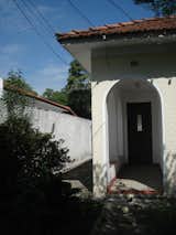 Before: Subtle changes to the front entry (like a fresh stucco treatment to the exterior) gave the building new life.   Photo 5 of 20 in Before & After: A Pavilion-Like Addition Opens Up a São Paulo Home for Three Generations