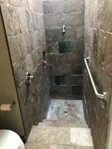 BEFORE: The sunken shower was originally lined in oversized tiles. 