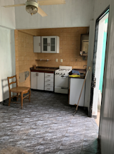 BEFORE: The dining room flooring would be torn up to make way for a concrete-like, smooth, minimalist finish.   Photo 1 of 25 in Before & After: In Buenos Aires, a Crumbling Home Gets a Major Refresh With a Rooftop Pool