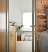 With the toilet and shower concealed by the door, the bathroom appears larger than its actual size.