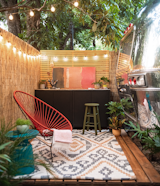 A functional workout space is set up beneath a heritage pecan tree outside the Armadillo’s door.  