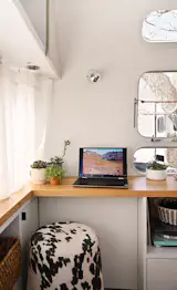 Pieces and finishes—a reclaimed wood desktop, a cozy animal-print stool—were selected to chime with the 1971 shell. “It was about embracing the imperfections,” says Ballard. 